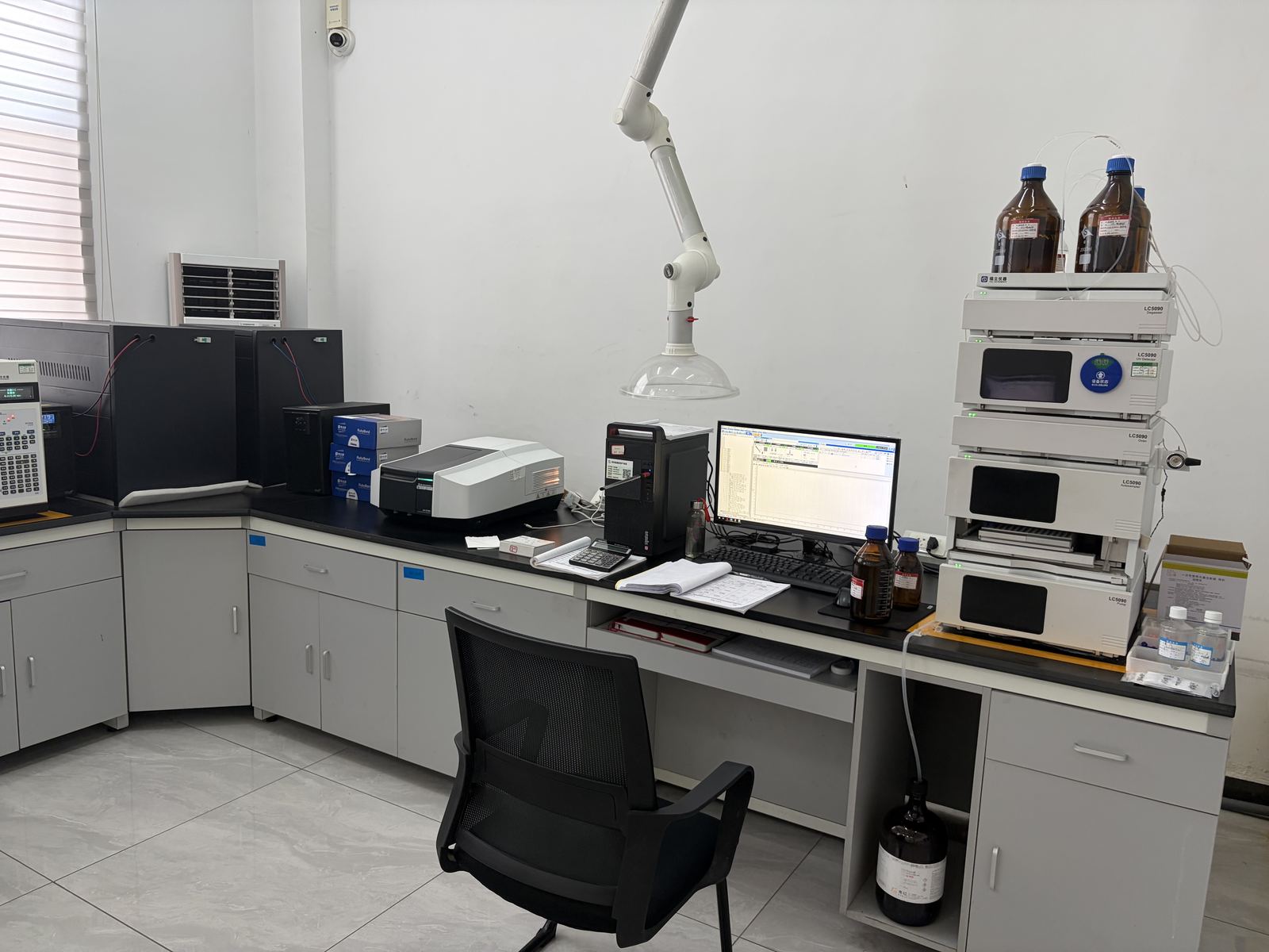 Quality control laboratory with an HPLC system, spectrophotometer and lab bench